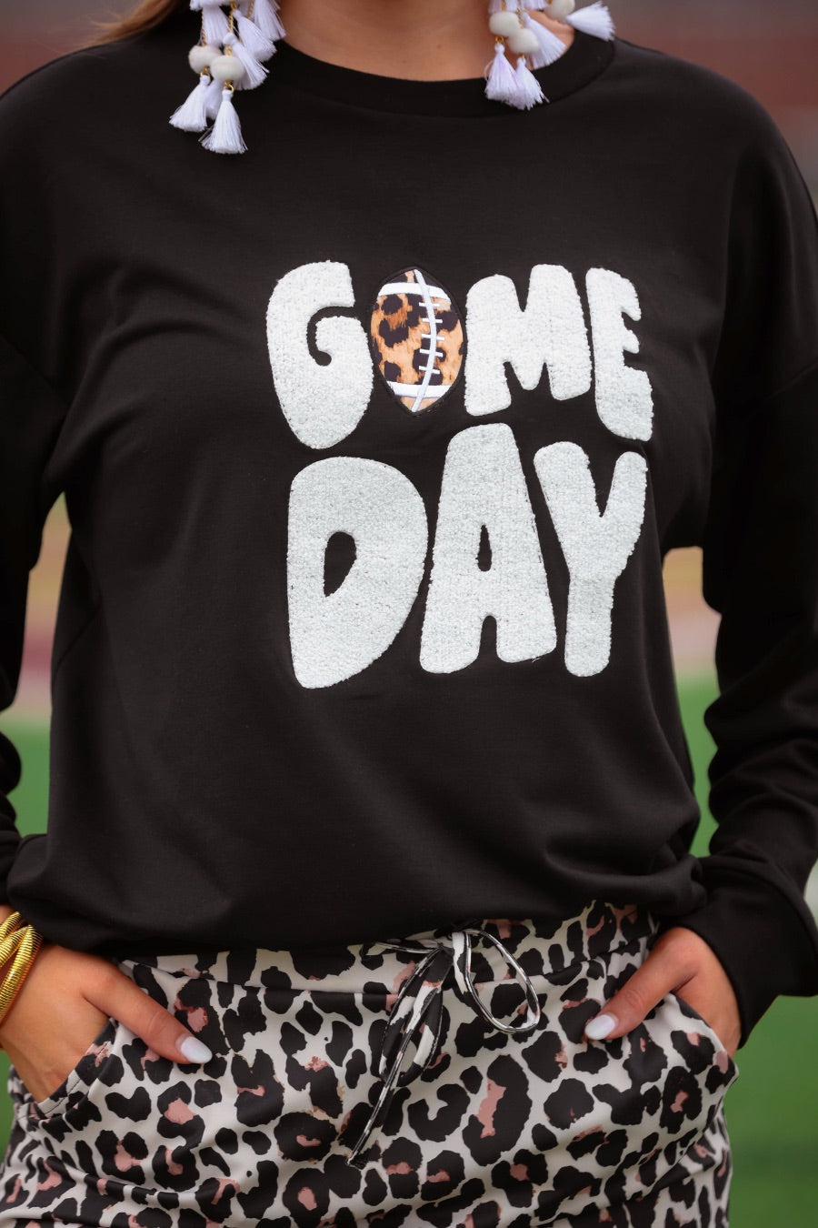 black long-sleeve sweatshirt with white chenille patch lettering reading GAME DAY in uppercase letters and a leopard football as the A in Game Day