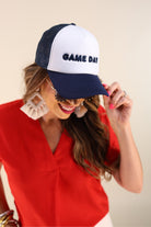 a lightweight navy two-tone trucker hat with raised embroidered 'GAME DAY' lettering, tall foam front panel, breathable mesh back, snapback closure, and a curved bill