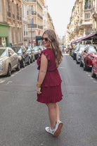 ruffled sleeve dress with layered pleats, an elastic waistband, and a lined bottom in burgundy