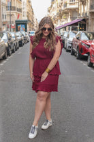 ruffled sleeve dress with layered pleats, an elastic waistband, and a lined bottom in burgundy