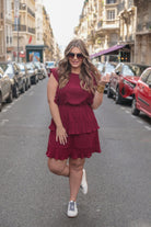 ruffled sleeve dress with layered pleats, an elastic waistband, and a lined bottom in burgundy