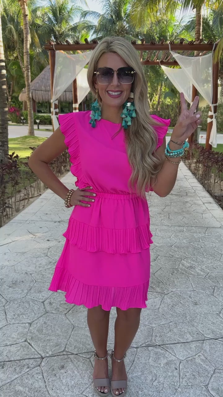 ruffled sleeve dress with layered pleats, an elastic waistband, and a lined bottom in pink