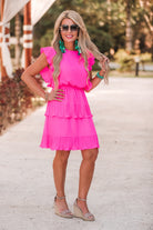 ruffled sleeve dress with layered pleats, an elastic waistband, and a lined bottom in pink