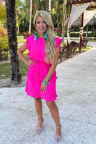 ruffled sleeve dress with layered pleats, an elastic waistband, and a lined bottom in pink