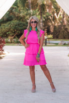ruffled sleeve dress with layered pleats, an elastic waistband, and a lined bottom in pink