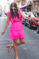 ruffled sleeve dress with layered pleats, an elastic waistband, and a lined bottom in pink