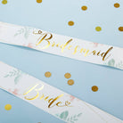 Bridal sashes with 'Bride' and 'Bridesmaid' text on a blue background with gold polka dots.