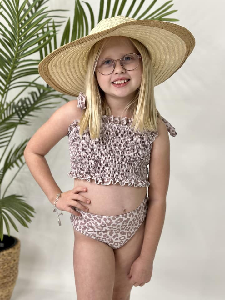 a stretchy ruched material top in natural leopard print, adjustable tie straps with built-in bralette lining, and matching high waisted bottoms