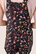 multicolor floral pattern print overall shorts on a black base made from our best-selling everyday fabric with functional button straps, cuffed hems, and side pockets