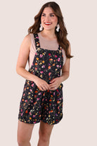 multicolor floral pattern print overall shorts on a black base made from our best-selling everyday fabric with functional button straps, cuffed hems, and side pockets