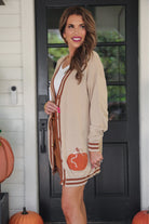 long-sleeve open front cardigan adorned with chenille pumpkins and sequin bows, functional pockets, and a relaxed fit in neutral