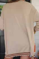 long-sleeve open front cardigan adorned with chenille pumpkins and sequin bows, functional pockets, and a relaxed fit in neutral