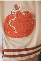long-sleeve open front cardigan adorned with chenille pumpkins and sequin bows, functional pockets, and a relaxed fit in neutral