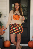 long-sleeve sweater with an oversized pumpkin, brown ribbed detailing (cuffs, neckline, and hem), and hem in brown, and a relaxed fit on a neutral base