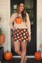 long-sleeve sweater with an oversized pumpkin, brown ribbed detailing (cuffs, neckline, and hem), and hem in brown, and a relaxed fit on a neutral base