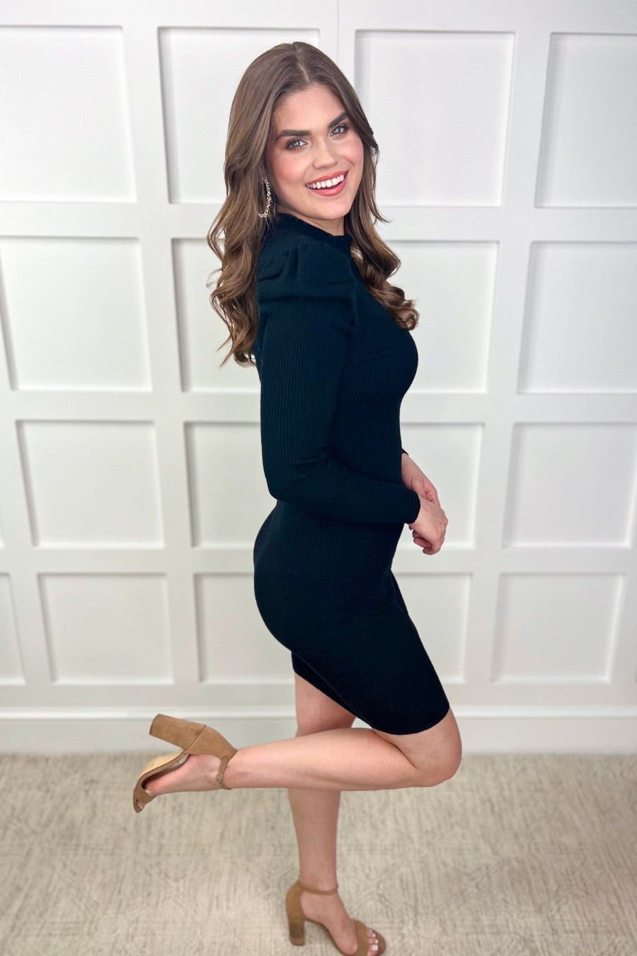 a mini bodycon dress with a flattering ribbed knit, long sleeves, a sophisticated mock neckline, and stylish puff sleeves in black