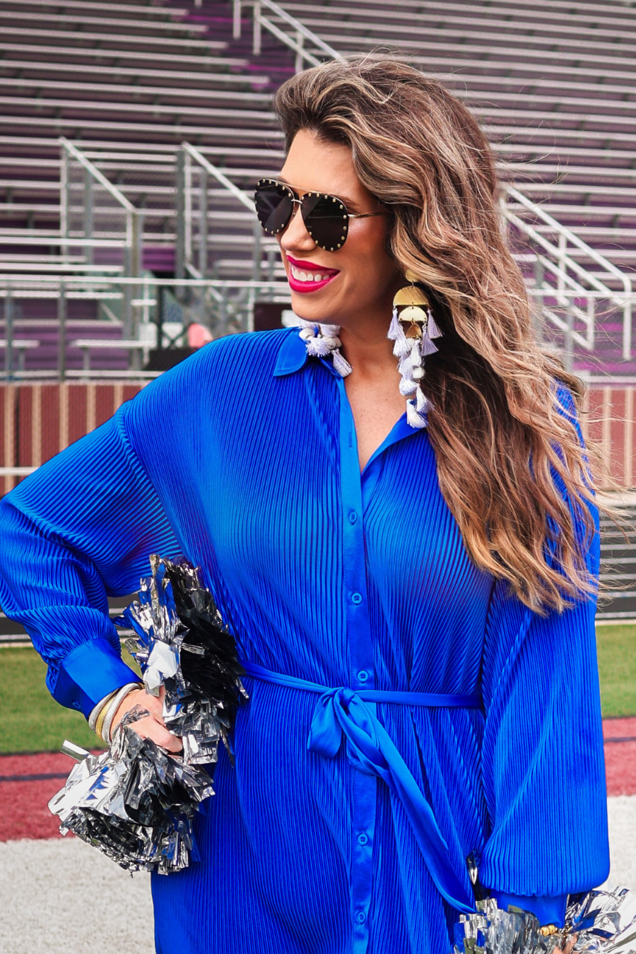a royal blue pleated shirt dress with a classic collar, functional button front, removable waist sash, drop shoulder long sleeves, satin cuffs, back yoke seam, accordion texture, and flowy mini-length silhouette