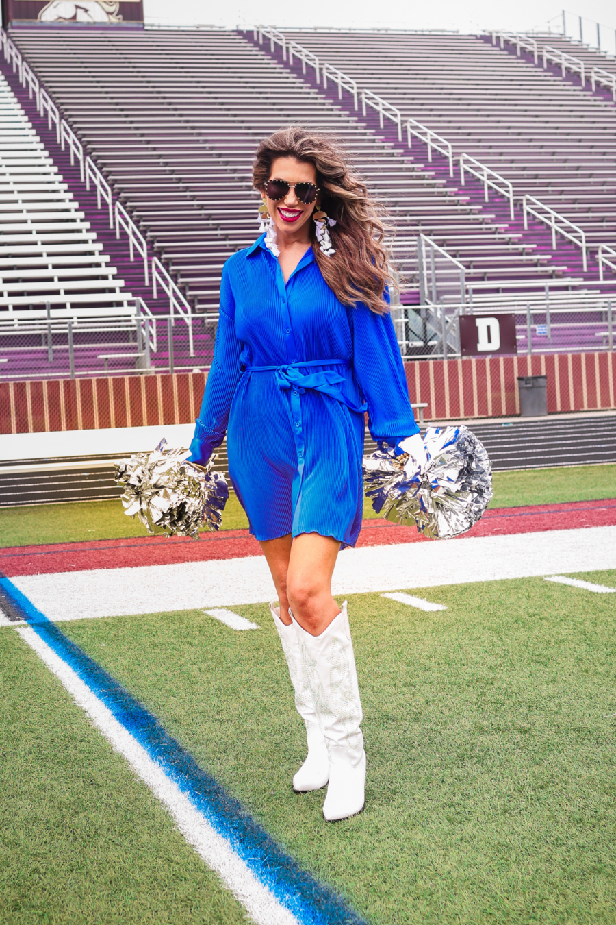 a royal blue pleated shirt dress with a classic collar, functional button front, removable waist sash, drop shoulder long sleeves, satin cuffs, back yoke seam, accordion texture, and flowy mini-length silhouette