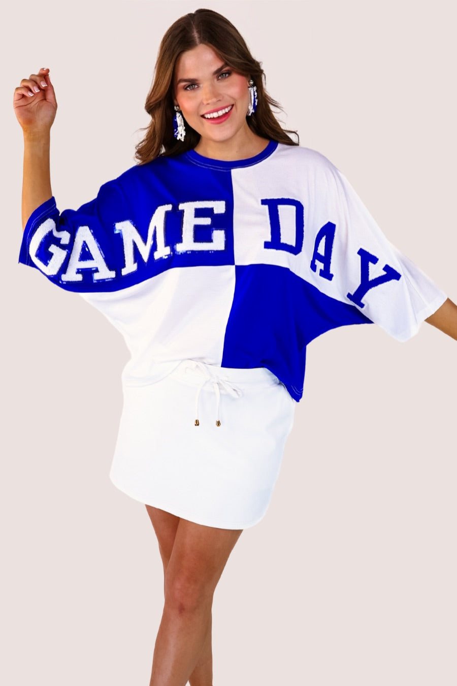 short-sleeve color block mom crop top with oversized chenille 'GAME DAY' lettering outlined in sequins, where GAME pops with a coordinating color outline to match the color block style, while DAY stands out with a crisp white outline in blue