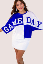 short-sleeve color block mom crop top with oversized chenille 'GAME DAY' lettering outlined in sequins, where GAME pops with a coordinating color outline to match the color block style, while DAY stands out with a crisp white outline in blue