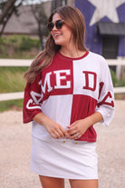 short-sleeve color block mom crop top with oversized chenille 'GAME DAY' lettering outlined in sequins, where GAME pops with a coordinating color outline to match the color block style, while DAY stands out with a crisp white outline in maroon