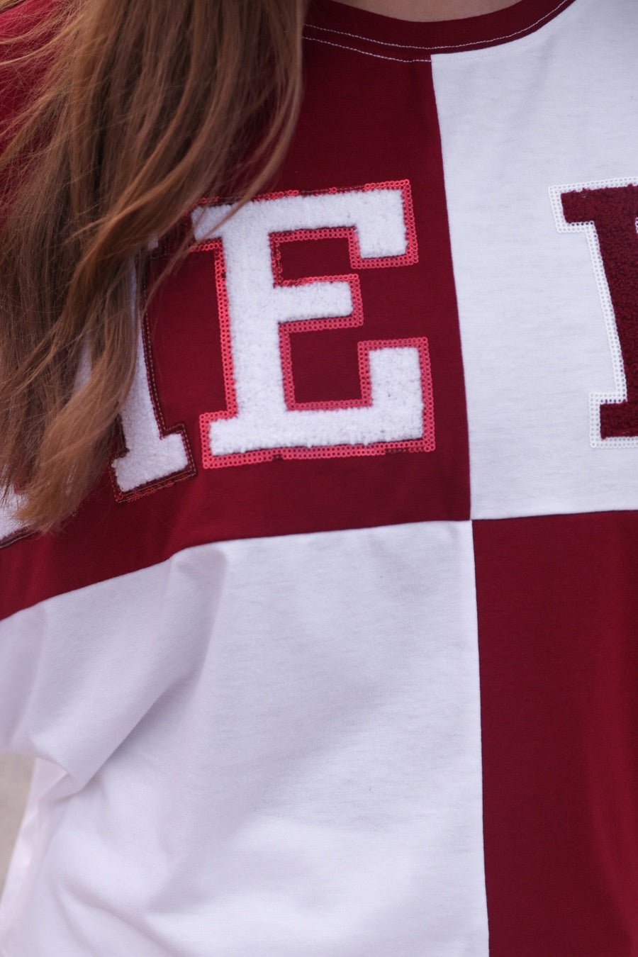 short-sleeve color block mom crop top with oversized chenille 'GAME DAY' lettering outlined in sequins, where GAME pops with a coordinating color outline to match the color block style, while DAY stands out with a crisp white outline in maroon