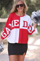 short-sleeve color block mom crop top with oversized chenille 'GAME DAY' lettering outlined in sequins, where GAME pops with a coordinating color outline to match the color block style, while DAY stands out with a crisp white outline in red