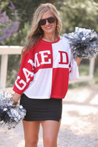short-sleeve color block mom crop top with oversized chenille 'GAME DAY' lettering outlined in sequins, where GAME pops with a coordinating color outline to match the color block style, while DAY stands out with a crisp white outline in red