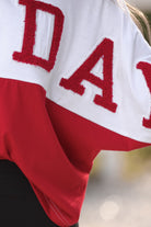 short-sleeve color block mom crop top with oversized chenille 'GAME DAY' lettering outlined in sequins, where GAME pops with a coordinating color outline to match the color block style, while DAY stands out with a crisp white outline in red