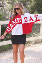 short-sleeve color block mom crop top with oversized chenille 'GAME DAY' lettering outlined in sequins, where GAME pops with a coordinating color outline to match the color block style, while DAY stands out with a crisp white outline in red