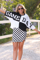 short-sleeve color block mom crop top with oversized chenille 'GAME DAY' lettering outlined in sequins, where GAME pops with a coordinating color outline to match the color block style, while DAY stands out with a crisp white outline in black