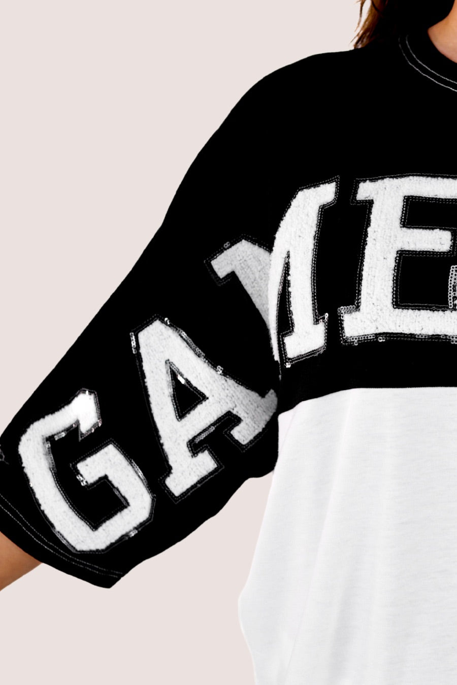 short-sleeve color block mom crop top with oversized chenille 'GAME DAY' lettering outlined in sequins, where GAME pops with a coordinating color outline to match the color block style, while DAY stands out with a crisp white outline in black