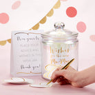 Wish jar with decorative text and a hand writing on a card against a polka dot background