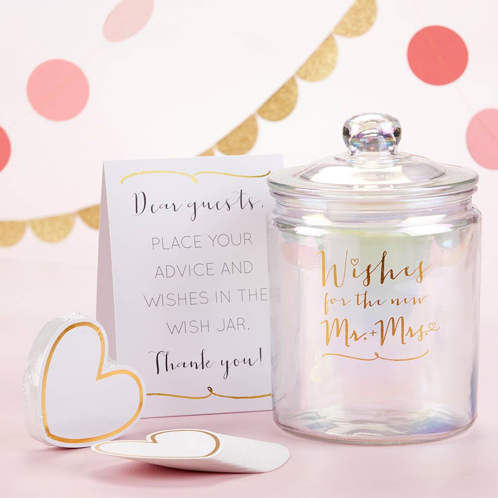 Glass wish jar with a decorative card on a pink background
