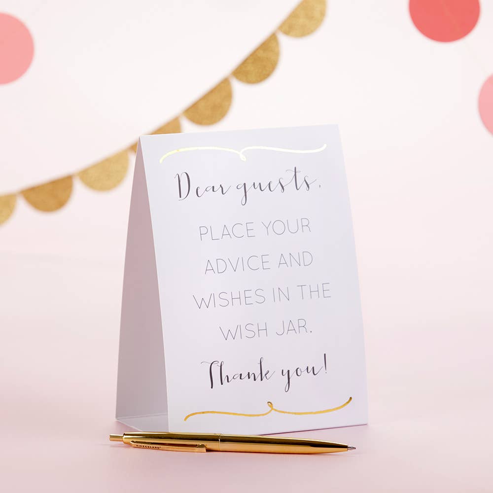 White card with text on a pink background with gold accents