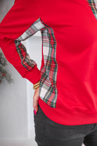 red long-sleeve pullover with a gold quarter-zip foldable collar and multicolor Scottish tartan plaid inserts on the neckline, sides, and underarms