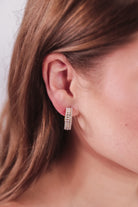 gold-plated hoop stud earring with three rows of delicate pearls, a comfort back earring, and a plastic disc stopper in gold