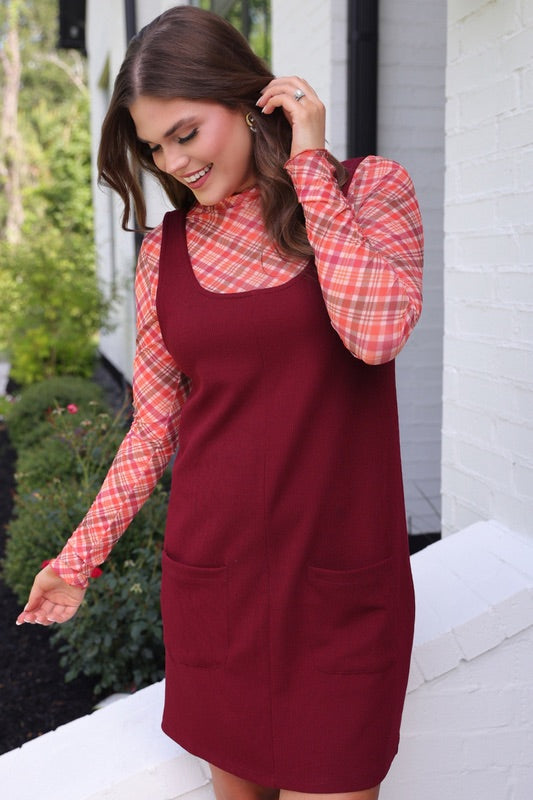 long-sleeve mesh top with a mock neckline and a lettuce hem on a plaid pattern (burgundy, brown, cream, and orange)