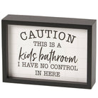 Decorative sign with text 'Caution: This is a kids' bathroom. I have no control in here.' in a black frame.