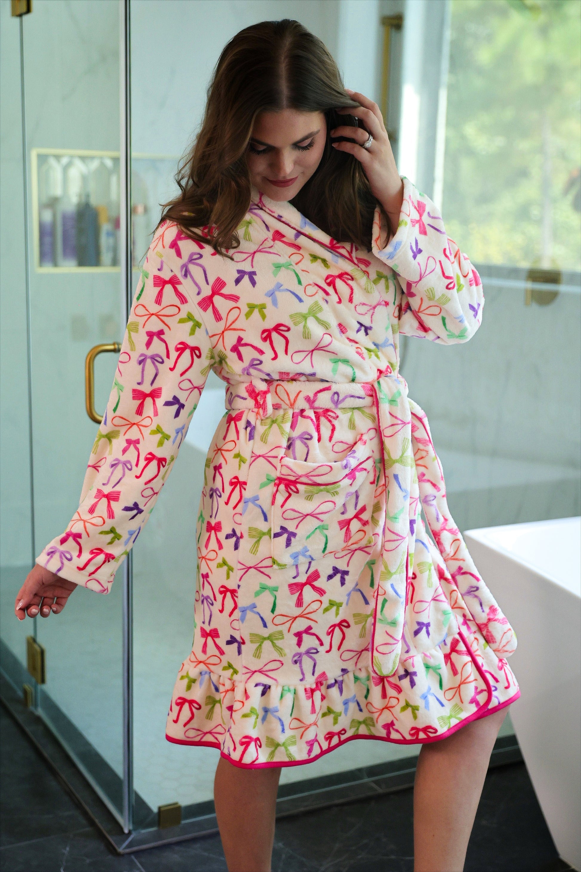 a long sleeve robe with a flattering wrap silhouette, an adjustable waist tie, a playful ruffle hem, and deep patch pockets on ultra plush fabric in Daylight Bow (Multi)