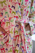 a long sleeve robe with a flattering wrap silhouette, an adjustable waist tie, a playful ruffle hem, and deep patch pockets on ultra plush fabric in Daylight Bow (Multi)