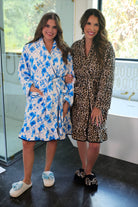 a long sleeve robe with a flattering wrap silhouette, an adjustable waist tie, a playful ruffle hem, and deep patch pockets on ultra plush fabric in Blue Blossom (Blue) and Safari Chic (Leopard)