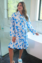a long sleeve robe with a flattering wrap silhouette, an adjustable waist tie, a playful ruffle hem, and deep patch pockets on ultra plush fabric in Blue Blossom (Blue)