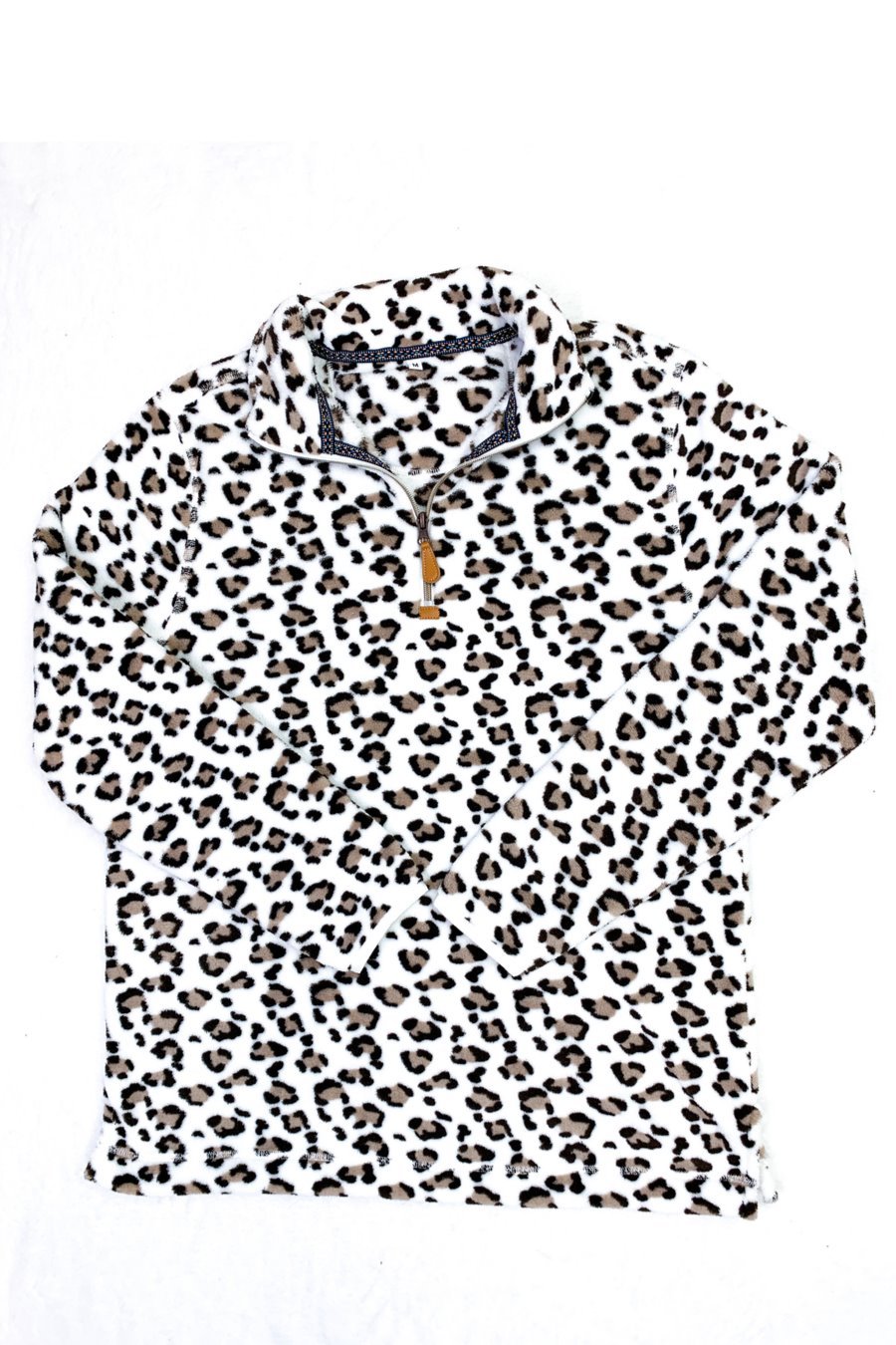 a long-sleeve pullover with a quarter zip, foldable collar, and a side split hem on a neutral leopard pattern fleece fabric