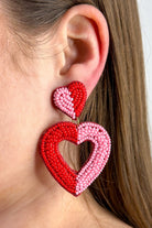 two-toned mirrored heart-shaped dangle earrings with a comfort back and a plastic disc stopper in gold