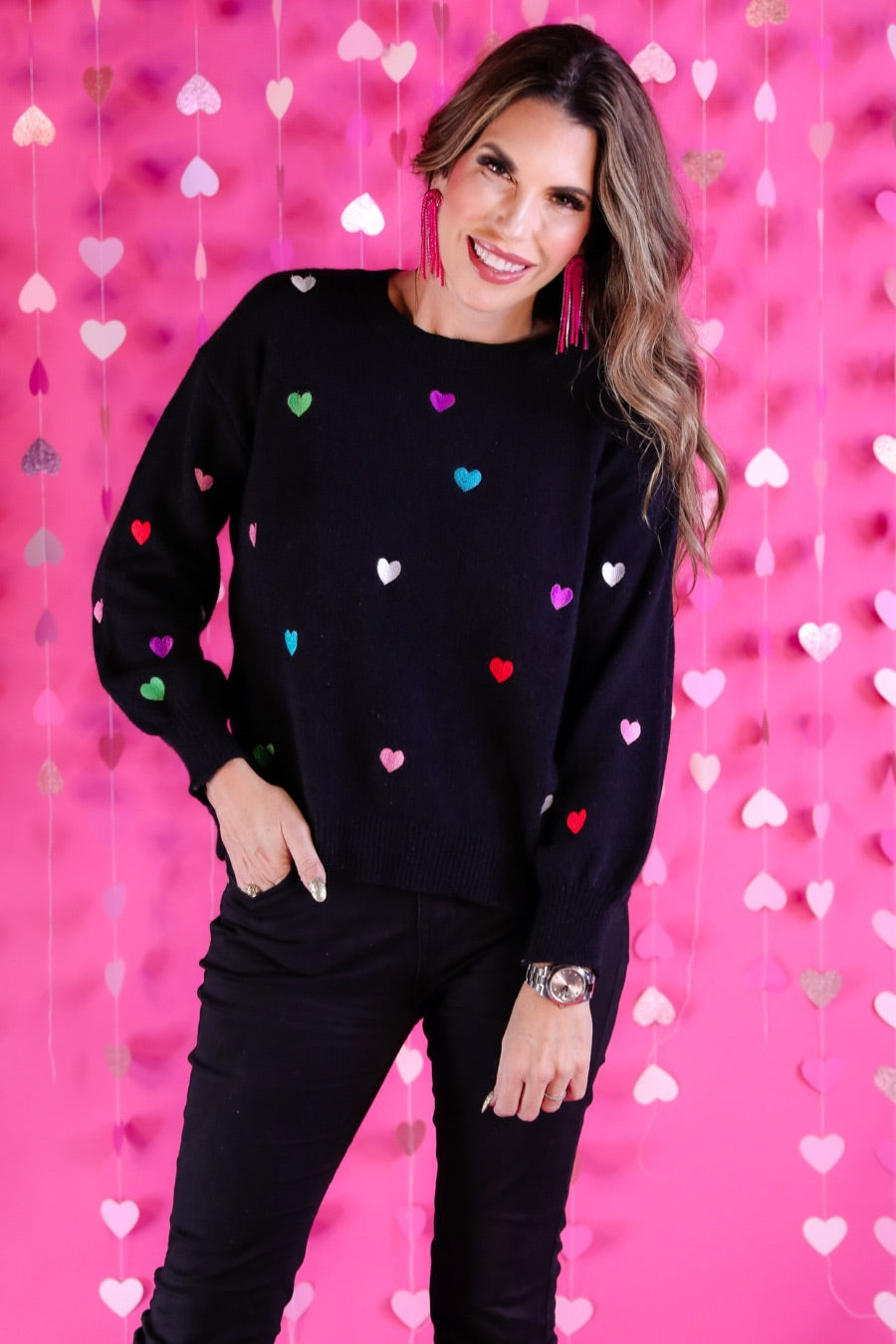 black long sleeve sweater adorned with colorful embroidered hearts