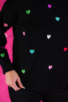 black long sleeve sweater adorned with colorful embroidered hearts