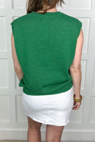 green sleeveless sweater vest with LUCKY tinsel white lettering