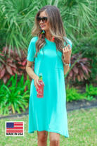 an ultra soft mint T-shirt dress with an easy A-line silhouette, short sleeves, a round neckline, a chest pocket, and a straight hemline with MADE IN USA watermark in the bottom left hand corner