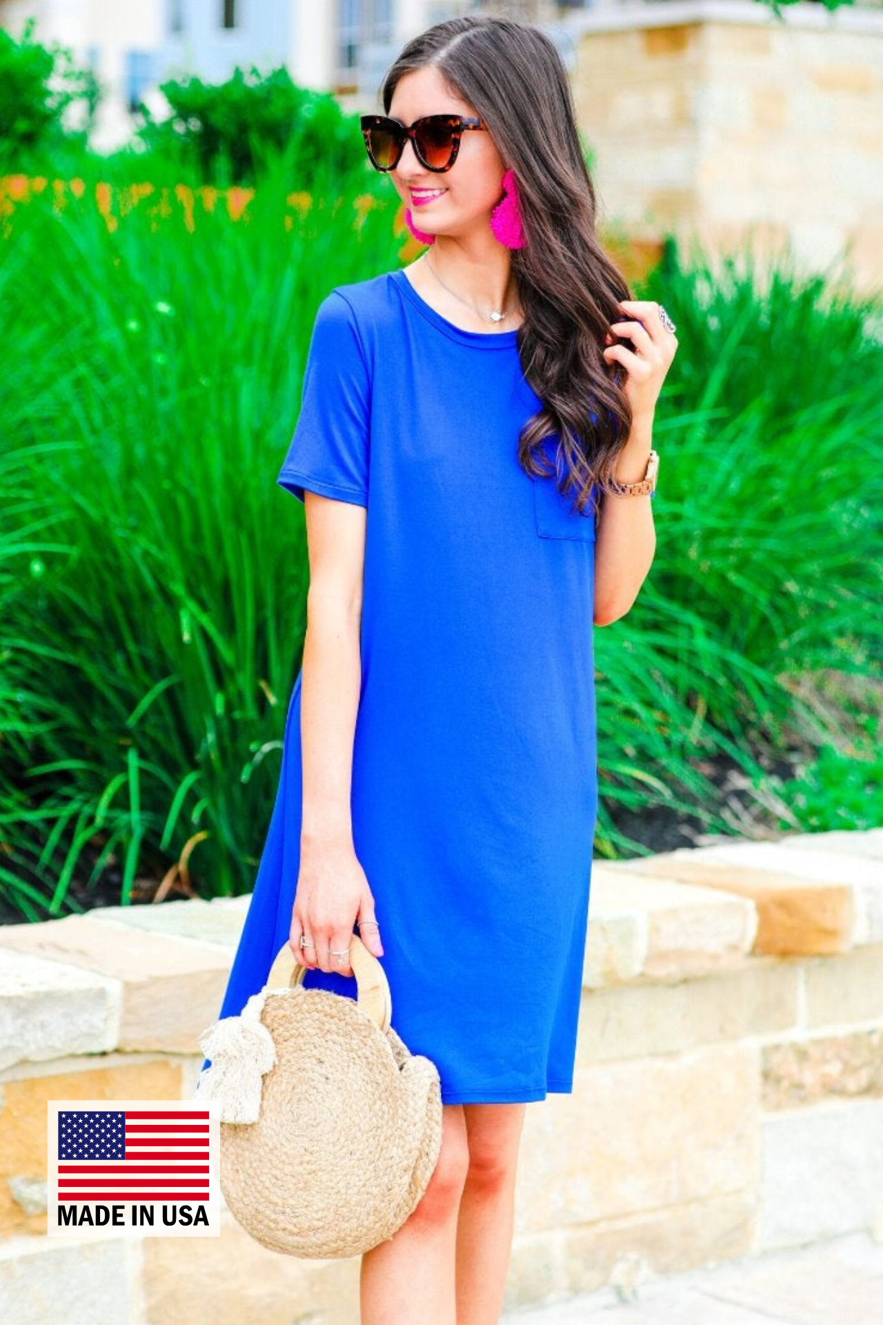 an ultra soft royal blue T-shirt dress with an easy A-line silhouette, short sleeves, a round neckline, a chest pocket, and a straight hemline with MADE IN USA watermark in the bottom left hand corner